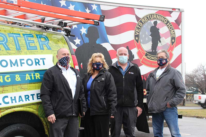 The team from Charter Home Comfort, Young Supply, and Vets Returning Home poses outside the Roseville facility for a photo.