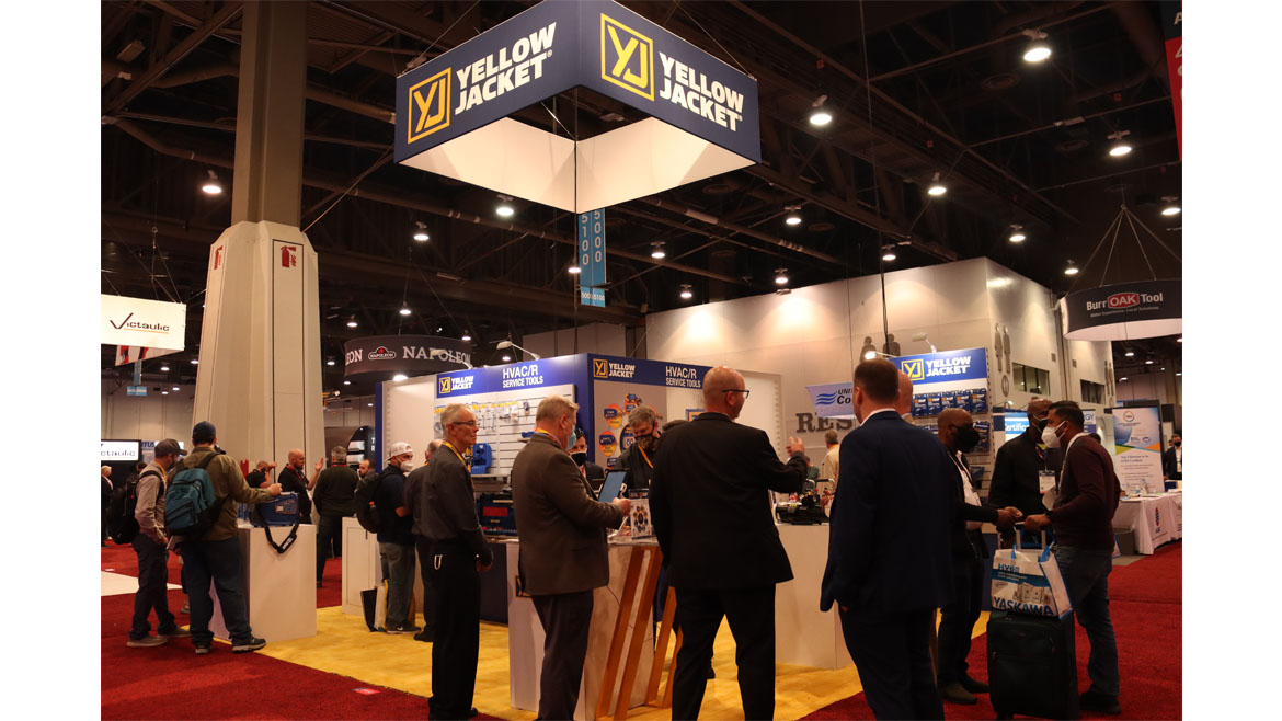 AHR attendees gather at the Yellow Jacket booth.