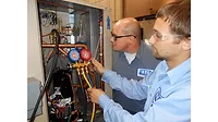 Technicians Servicing Refrigeration Equipment