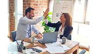 Male and Female Coworkers High Fiving