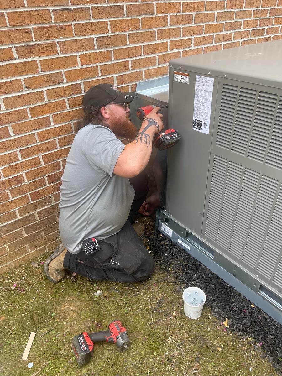 Technician servicing HVAC.