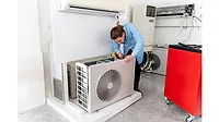 Technician working on heat pump