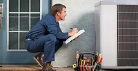 HVAC Technician in front of Air Conditioner