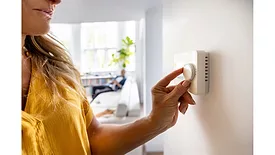 woman-adjusting-thermostat.jpg