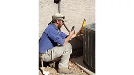 Technician-servicing-heat-pump.jpg