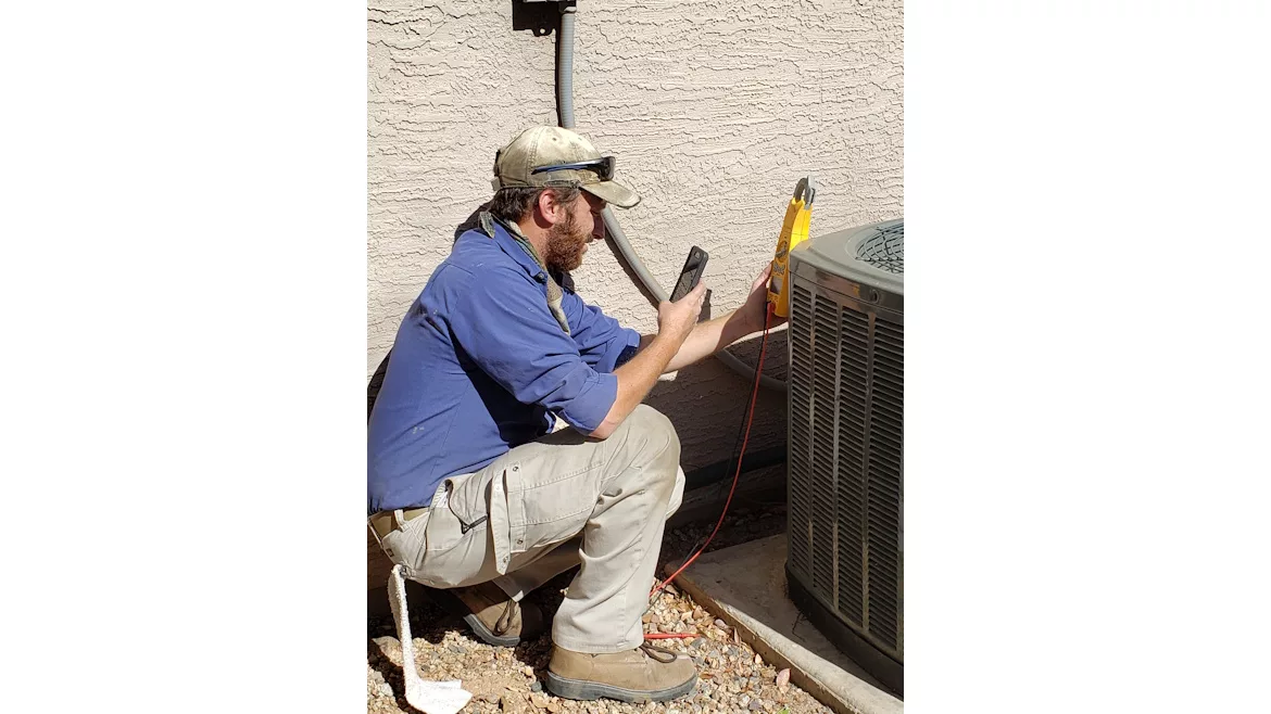 Technician-servicing-heat-pump.jpg