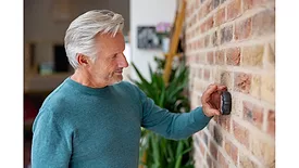 man-using-smart-thermostat.jpg
