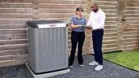 25C conflict photo.jpg technician and homeowner with Lennox heat pump