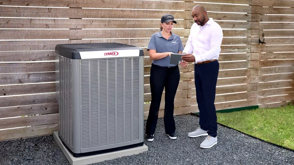 technician and homeowner with Lennox heat pump