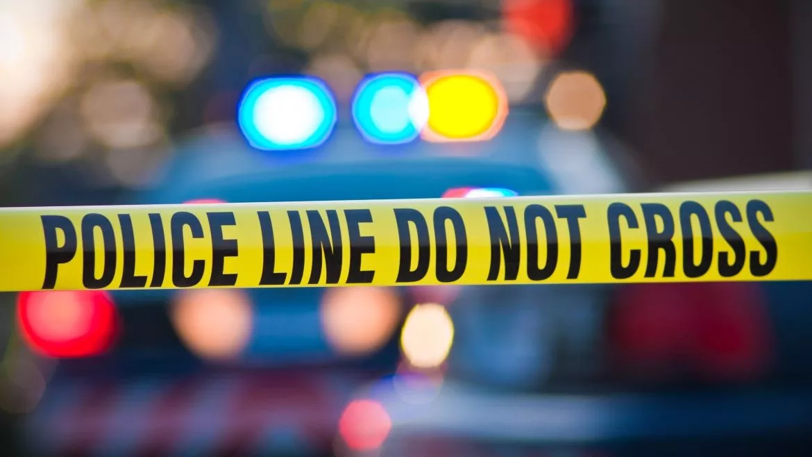 police tape with emergency lights in background
