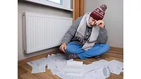 Man-in-winter-clothes-with-heating-bills.jpg