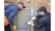 HVAC-techs-checking-unit-with-tablet.jpg