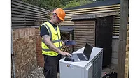 Tech-with-computer-heat-pump.jpg Tech-with-computer-heat-pump.jpg