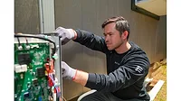 07-15-26 TRENDING BDC report photo.JPG Man installing heat pump outside house
