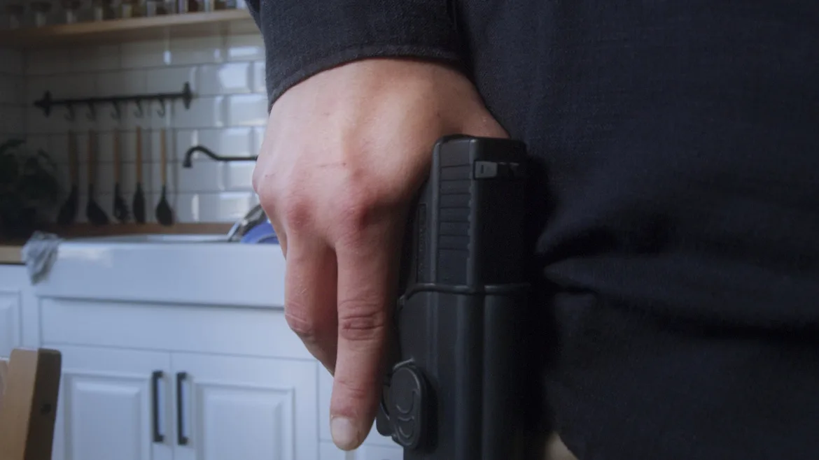 Grabbing-gun-in-kitchen.jpg