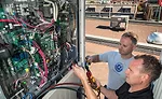Tim Sykes and Tyler Little, co-founders of Capital City Refrigeration, check connections on a VRF system.