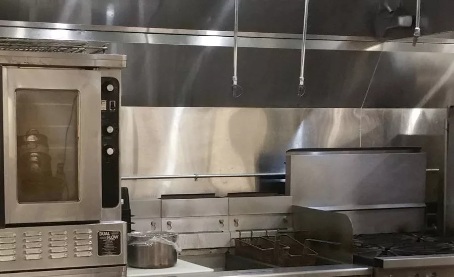 Stainless steel baffle between front and back cooking lines