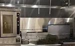 Stainless steel baffle between front and back cooking lines