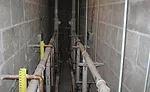 A plumbing fixture group back-to-back chase with PVC waste and vent piping and copper water piping