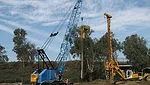crane, machinery along road