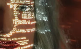 woman with code reflected on her face