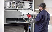 technician working on HVAC system technician working on HVAC system