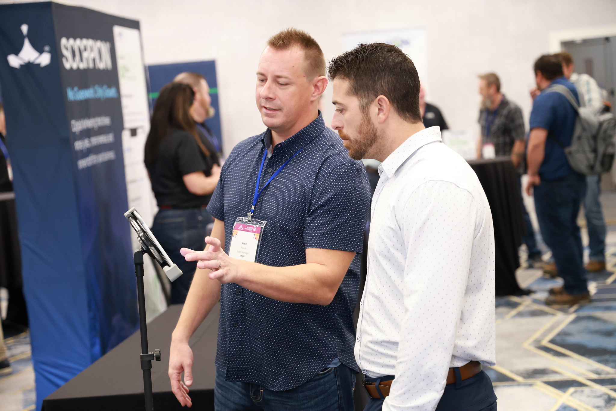 attendees at an exhibitor booth at a conference