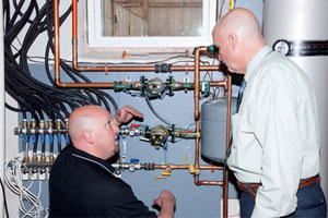 David Holdorf, Taco's Residential Trainer & Rep Training Manager, Eastern Region (left) and Steve Anderson, Account Manager for F.W. Webbâ??s Methuen Office, discuss integration of the hydronic systemâ??s key components.